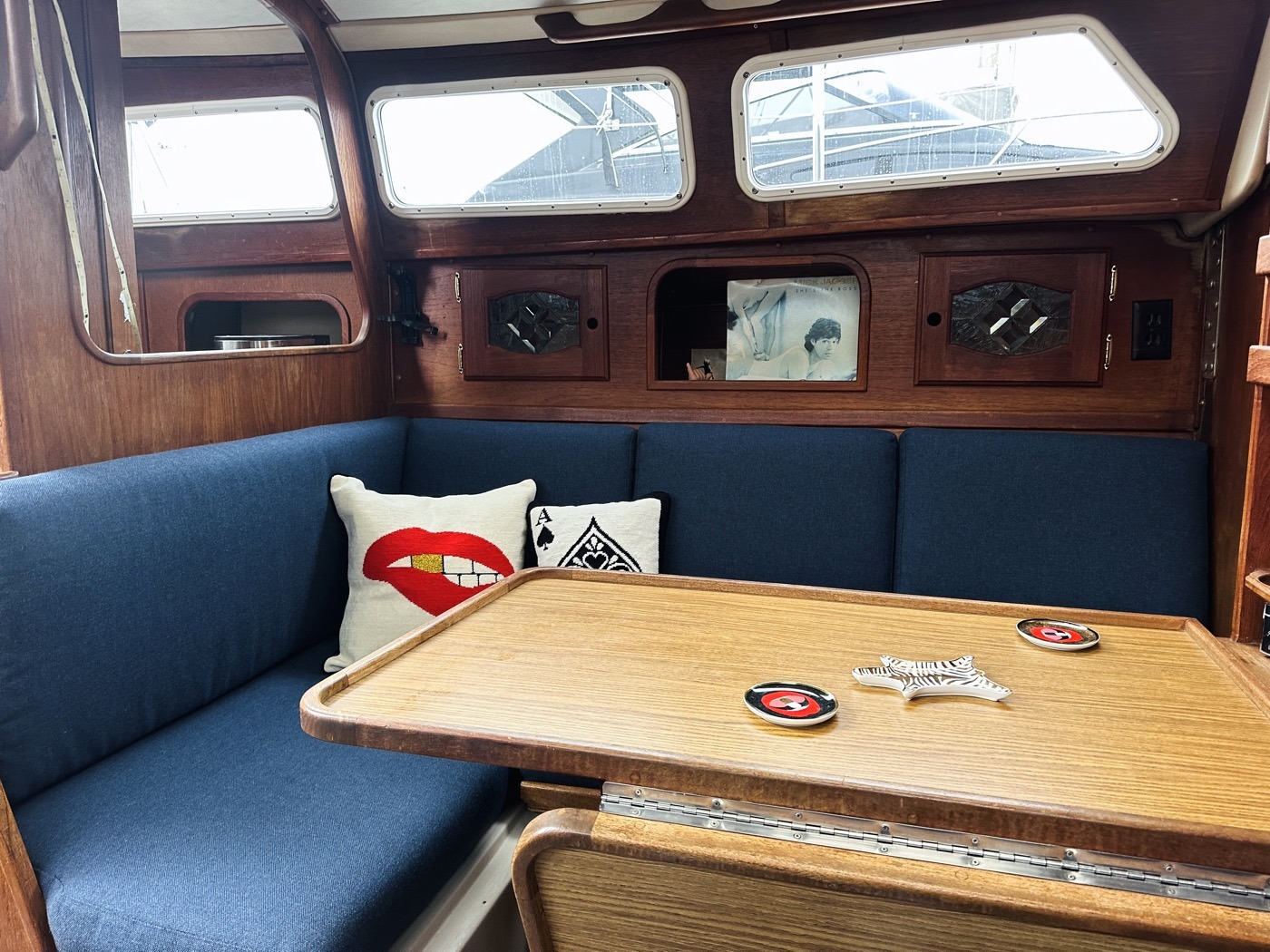 Teak dinette with navy settees aboard Moondawg