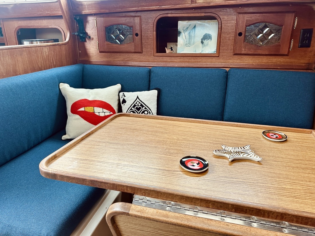 Teak table and blue seating in Moondawg’s salon